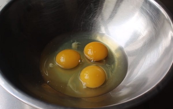Миска с тремя разбитыми яйцами
